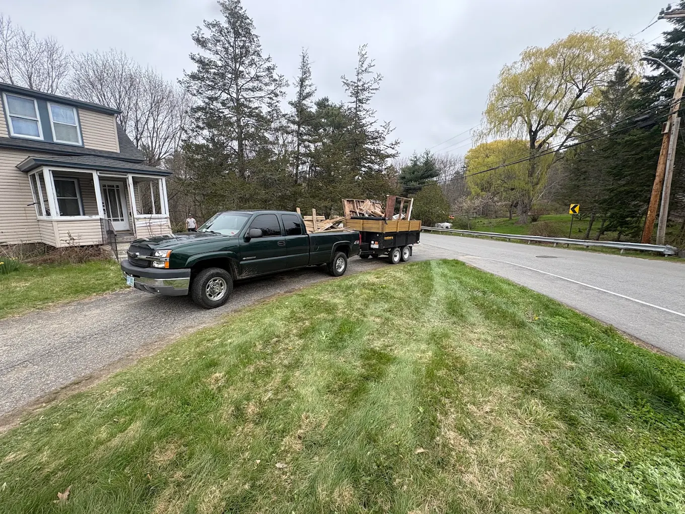 Round One Removal truck and loaded dump trailer at a New Hampshire home